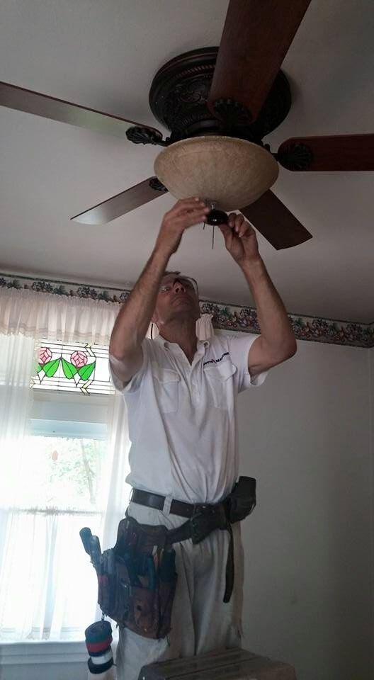 Man fixing ceiling fan— New Construction in Beaver, PA