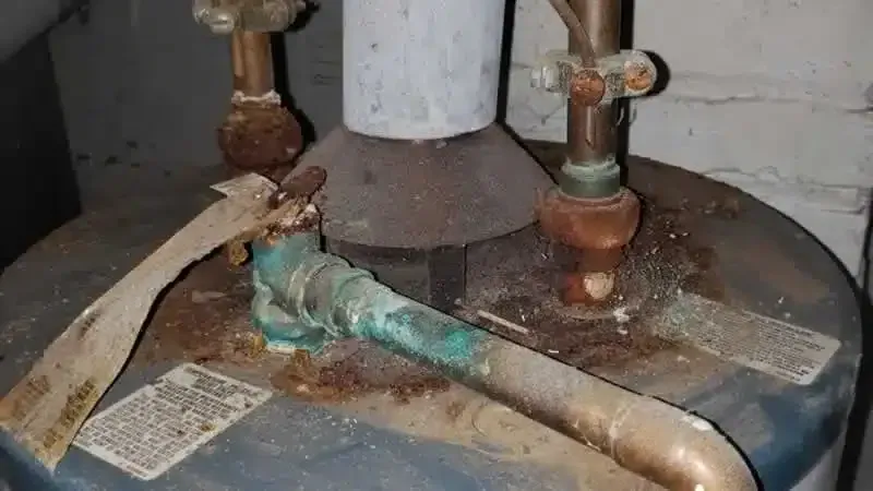 A wrench and hose are on top of a blueprint