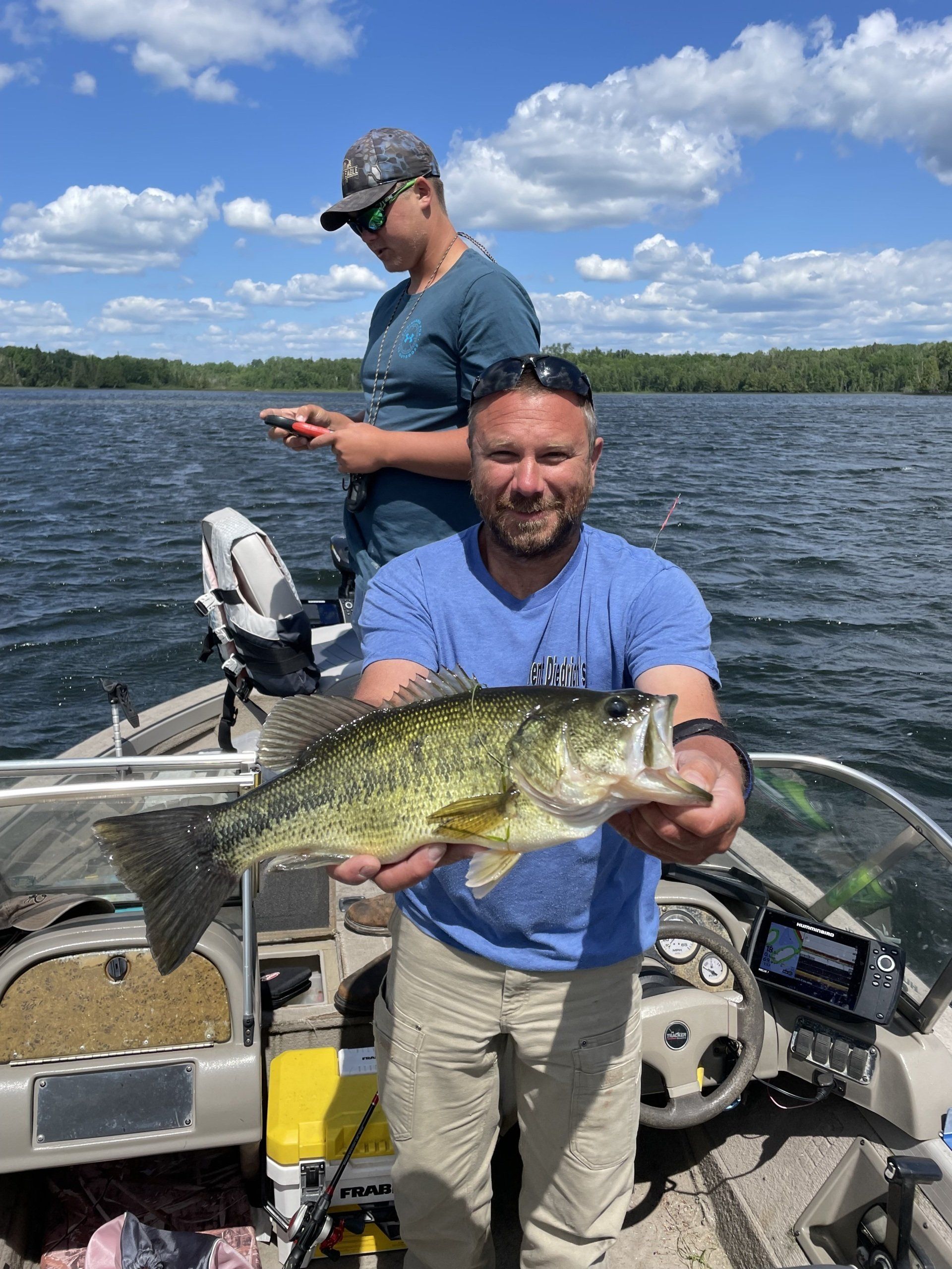 man-holding-fish-on-lake