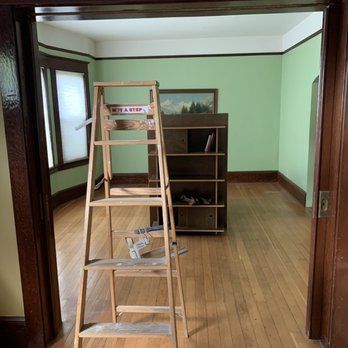 A wooden ladder in the middle of a room.