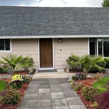 A house with a walkway leading to the front door