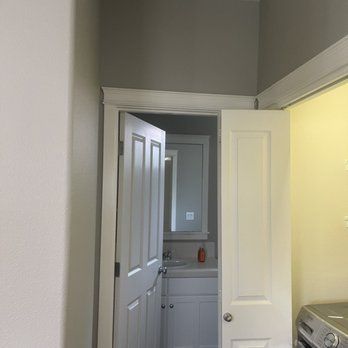 A kitchen with a refrigerator and a checkered floor.