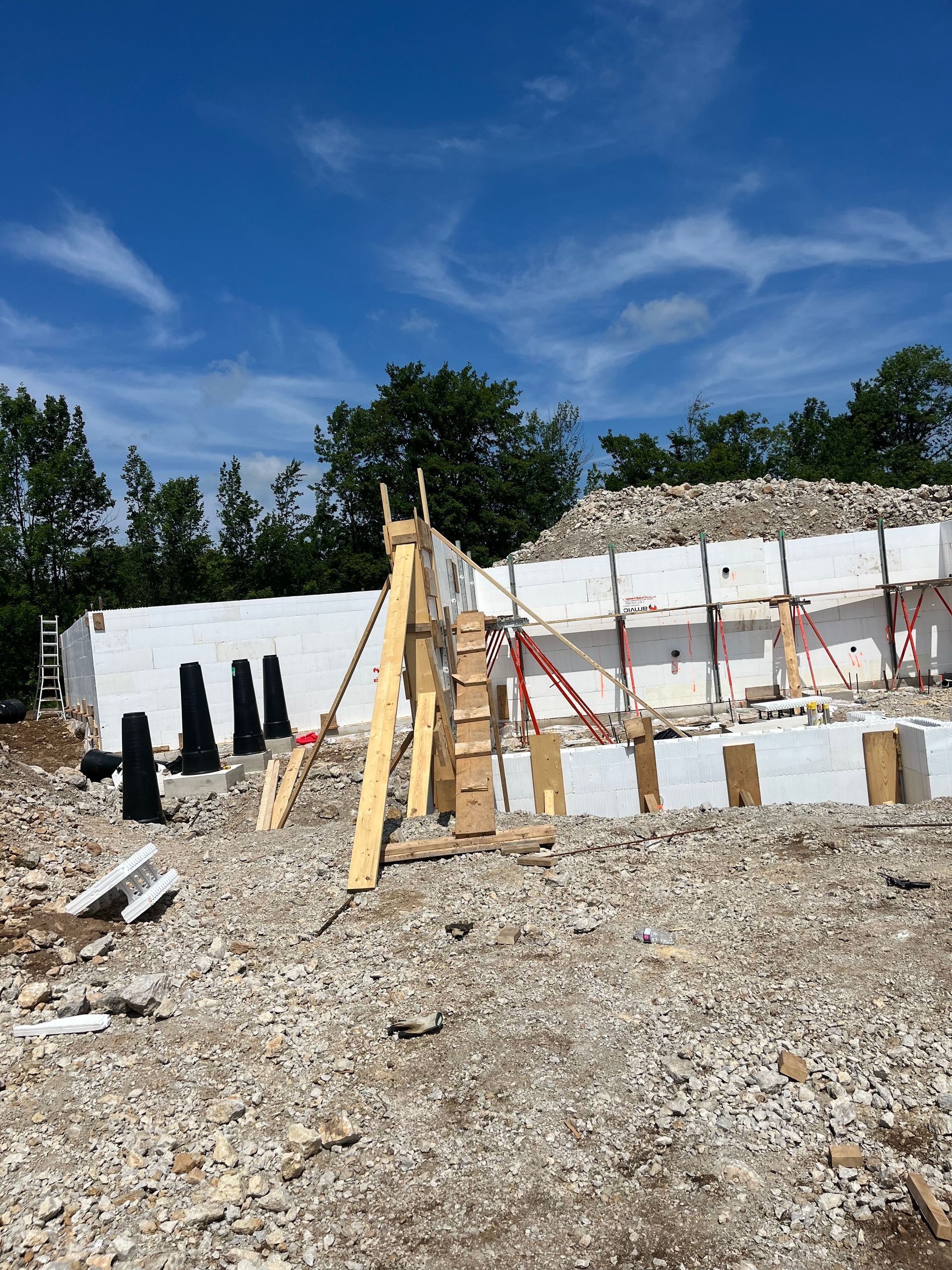 A construction site with a lot of rocks and a blue sky in the background.