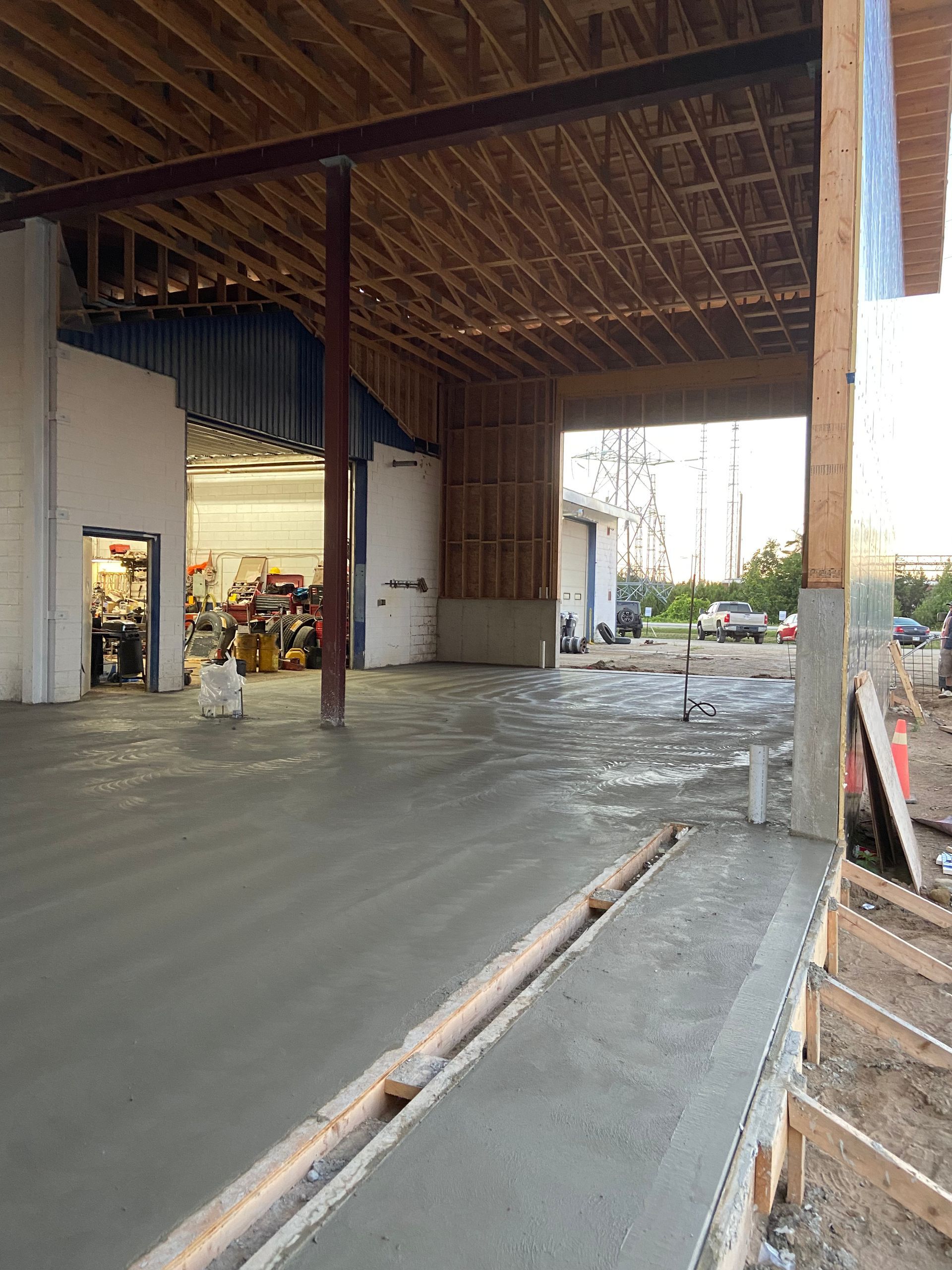 The inside of a building under construction with a concrete floor.