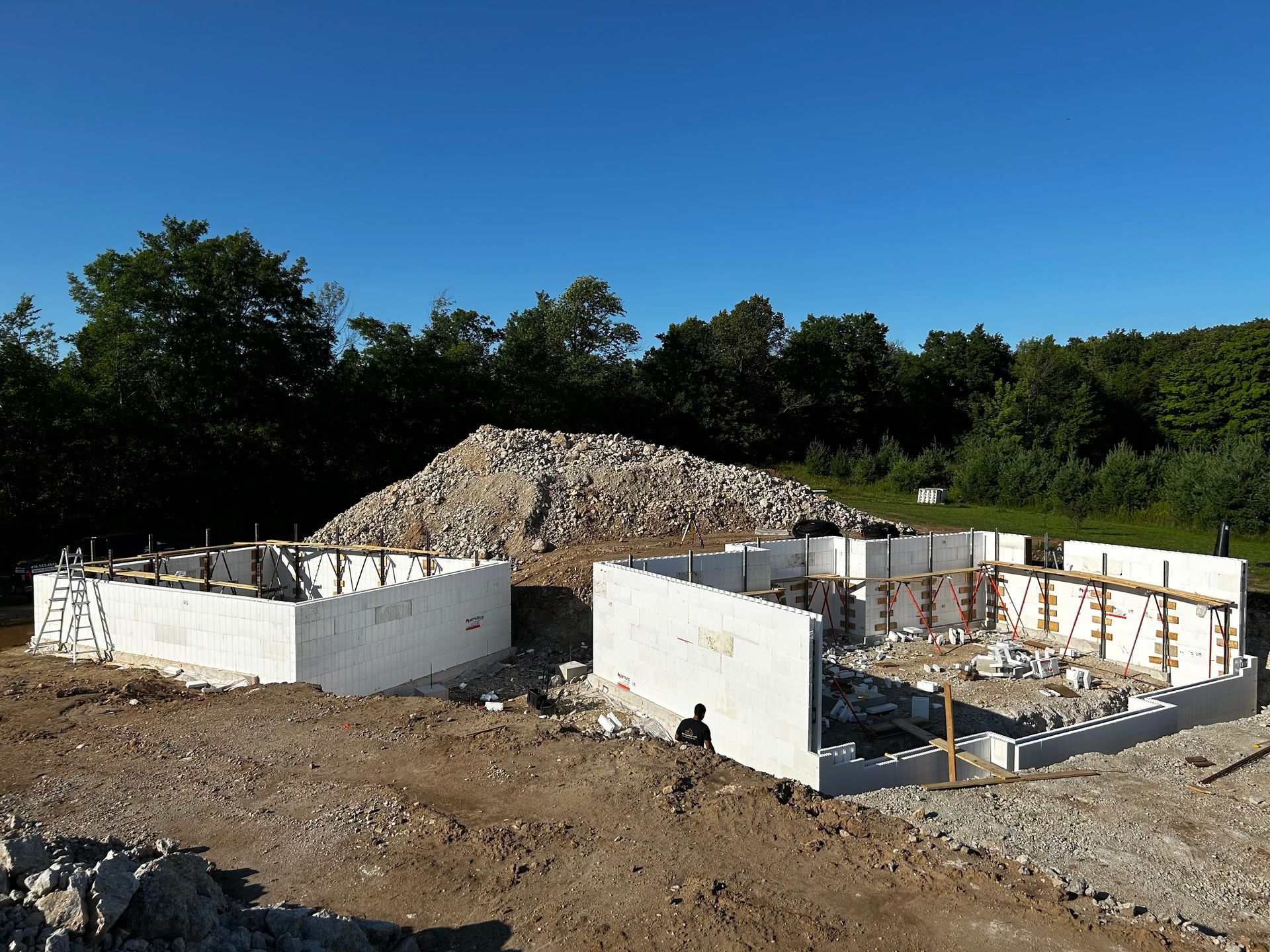 A construction site with a pile of rocks in the background