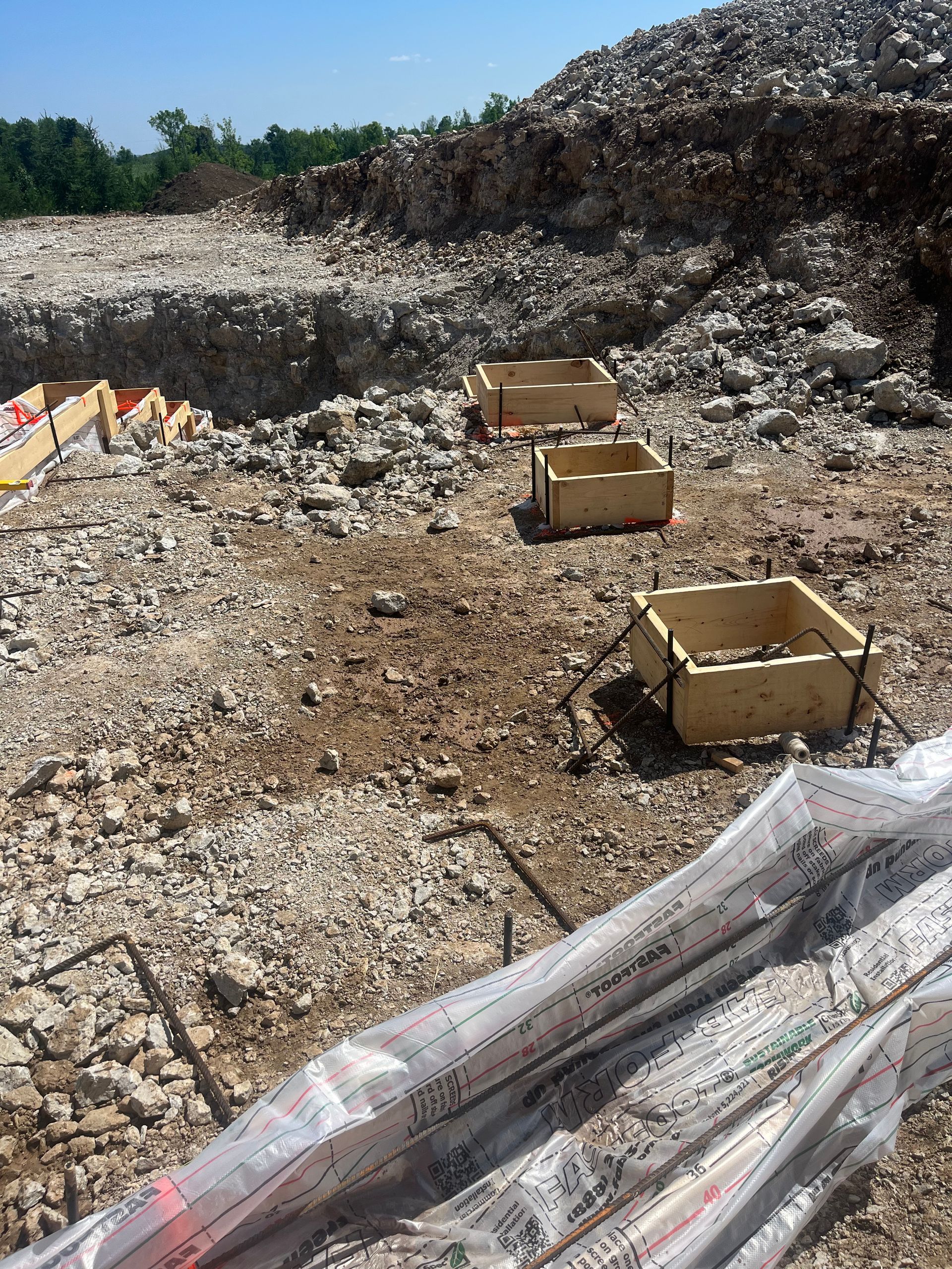 A pile of wooden boxes sitting on top of a pile of rocks.