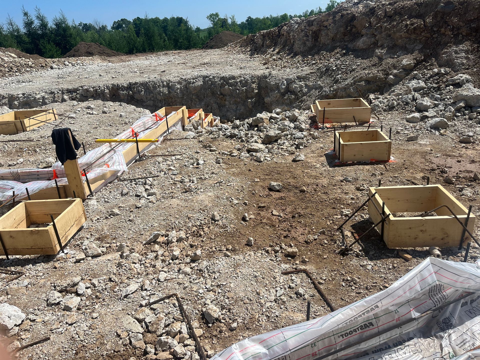 A construction site with a lot of wooden boxes on the ground.