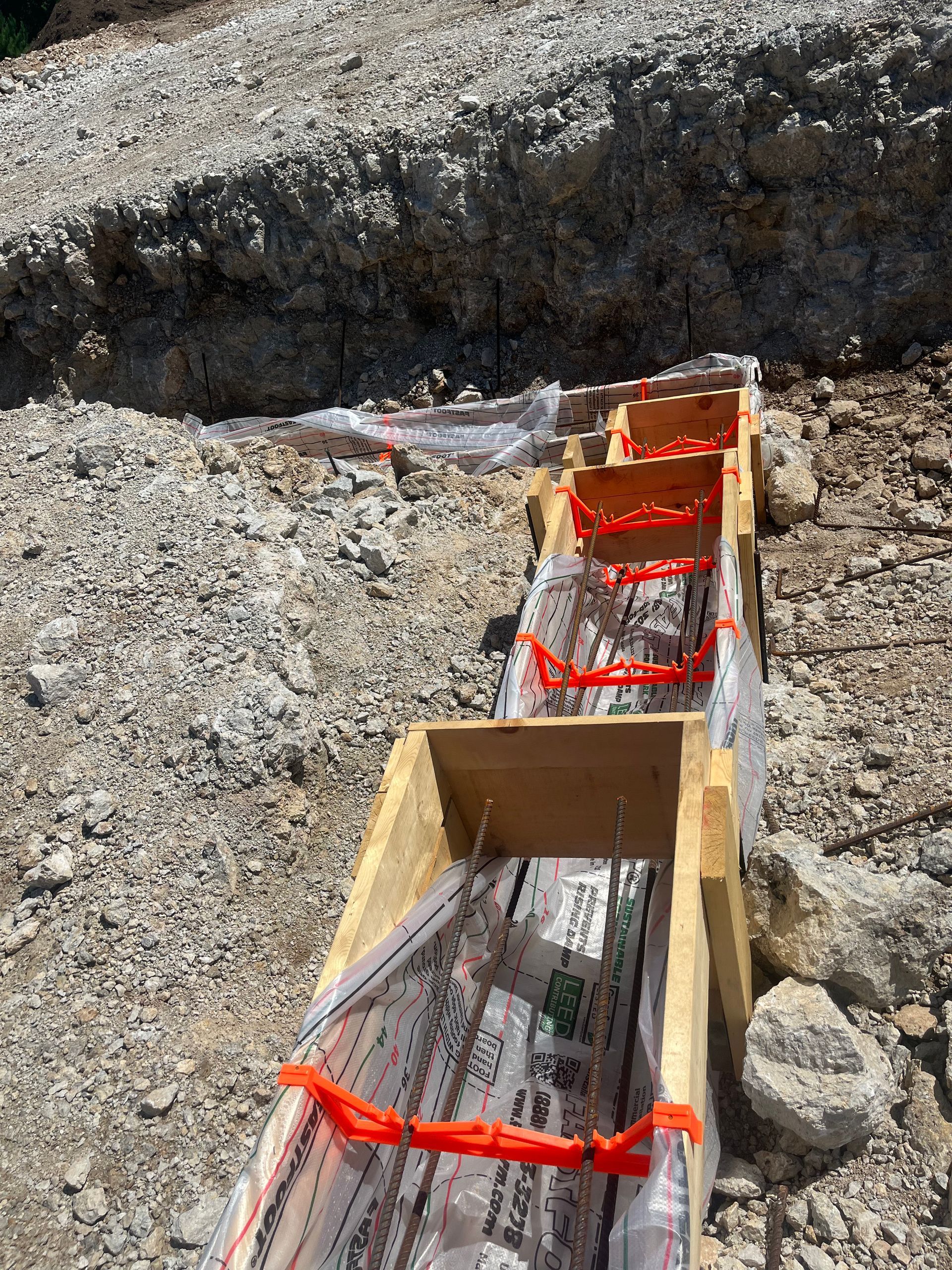 A row of wooden boxes sitting on top of a pile of rocks.