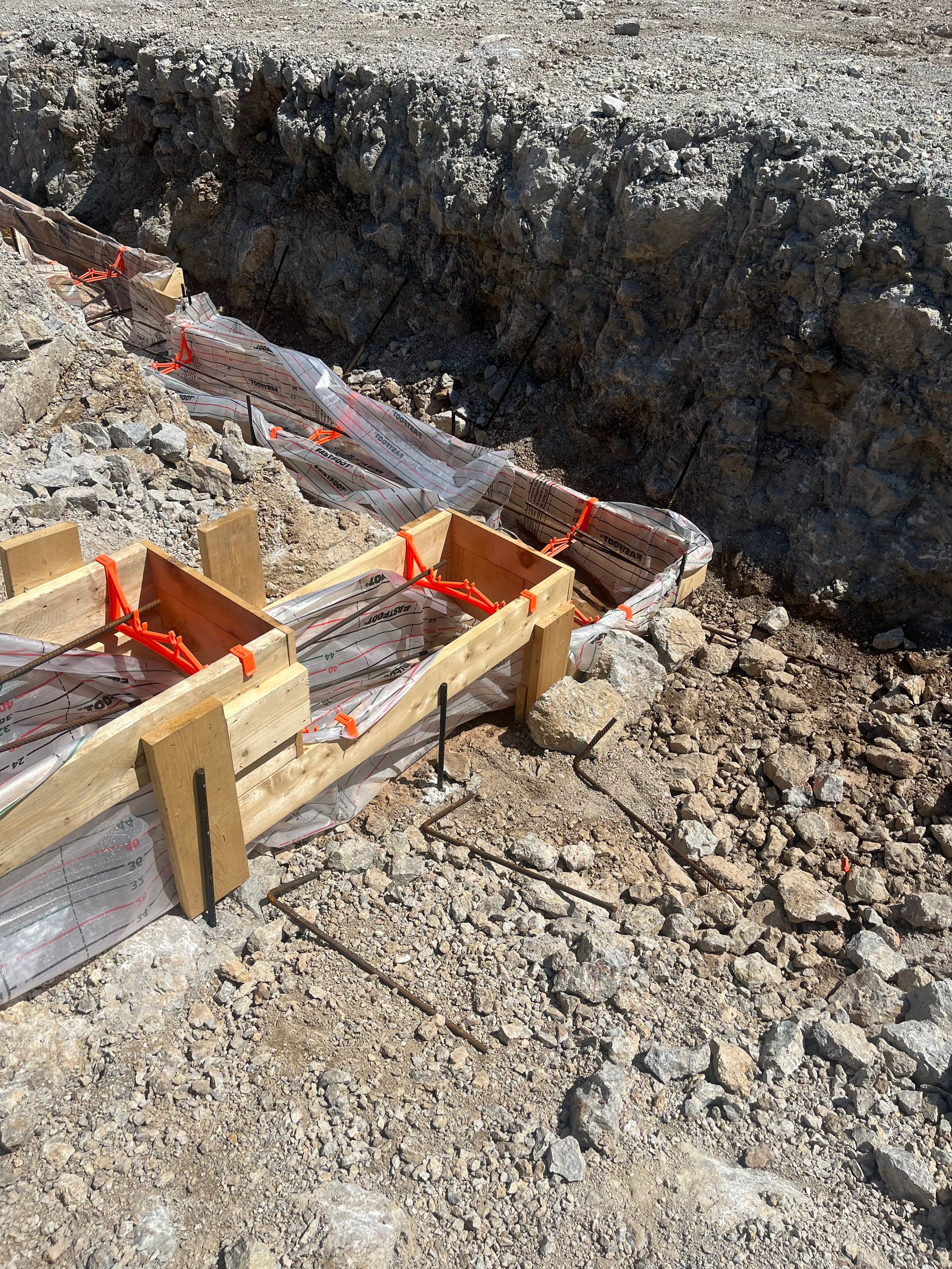 A couple of wooden boxes sitting on top of a pile of dirt.