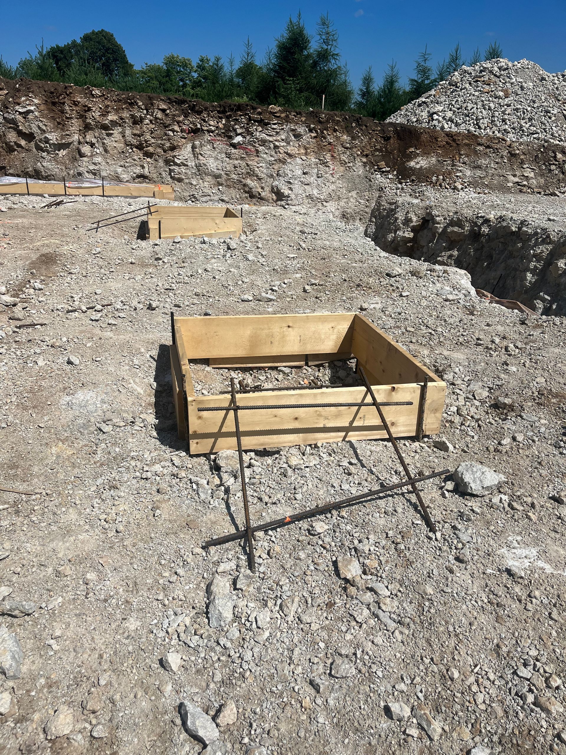 A wooden box is sitting on top of a pile of rocks.