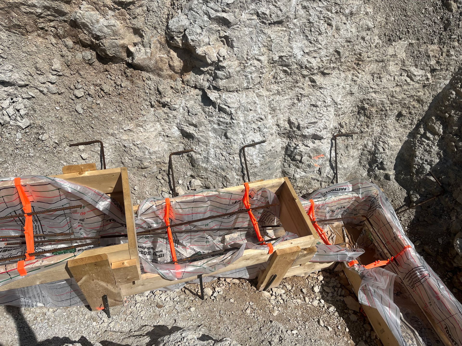 A couple of boxes sitting on top of a pile of dirt.