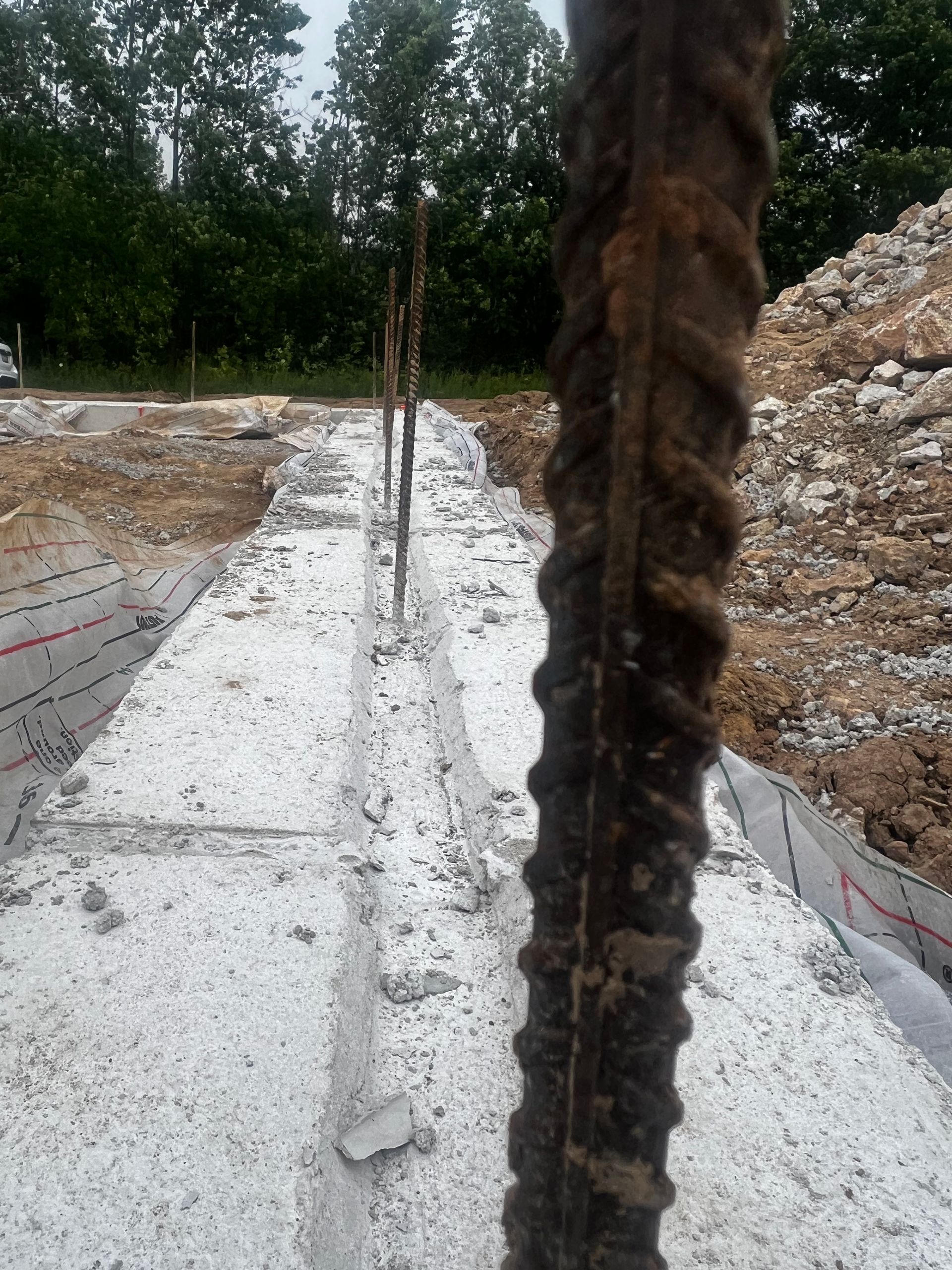 A close up of a metal pole on a construction site.