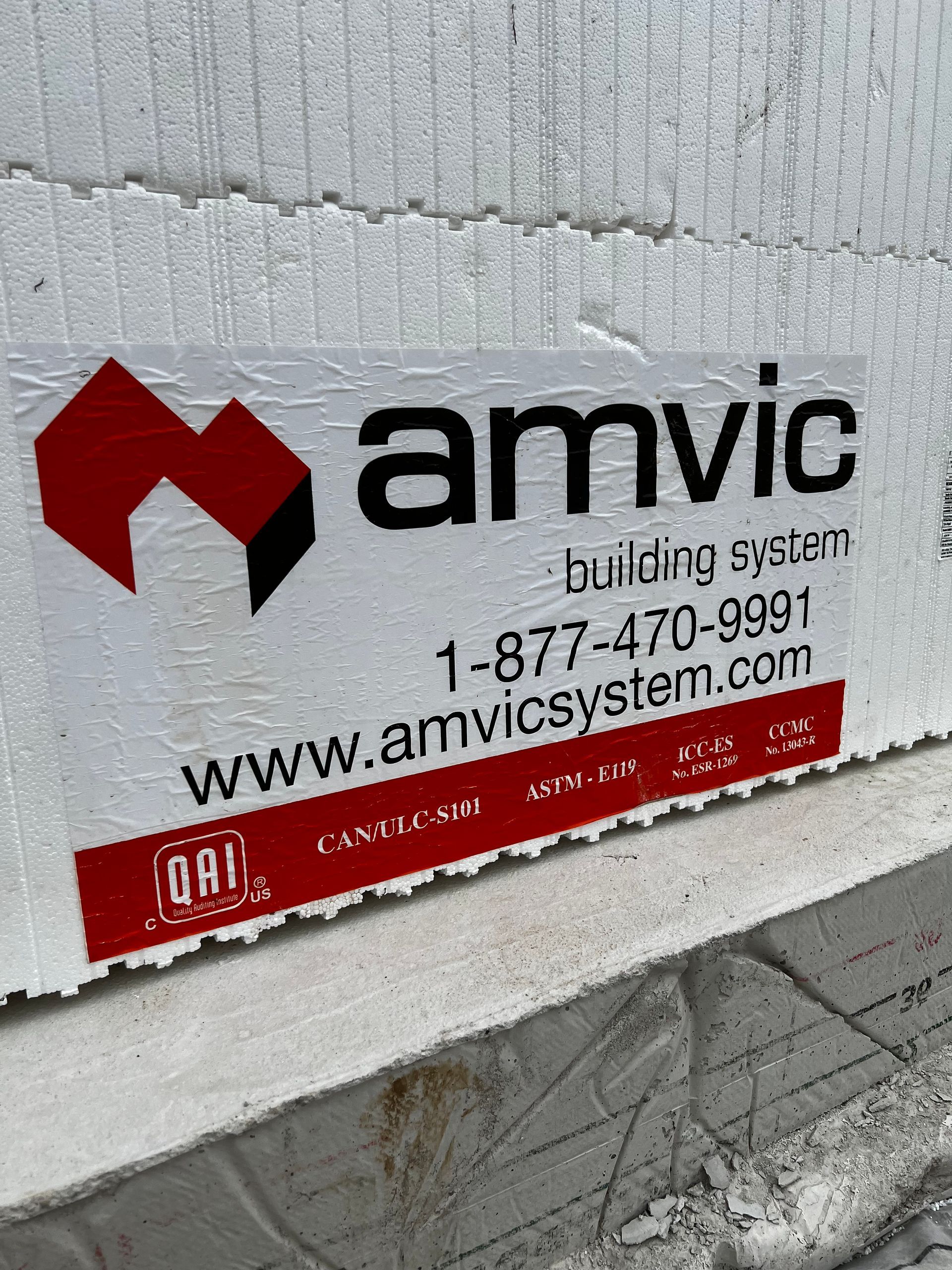 A sign on a wall that says amvic building system