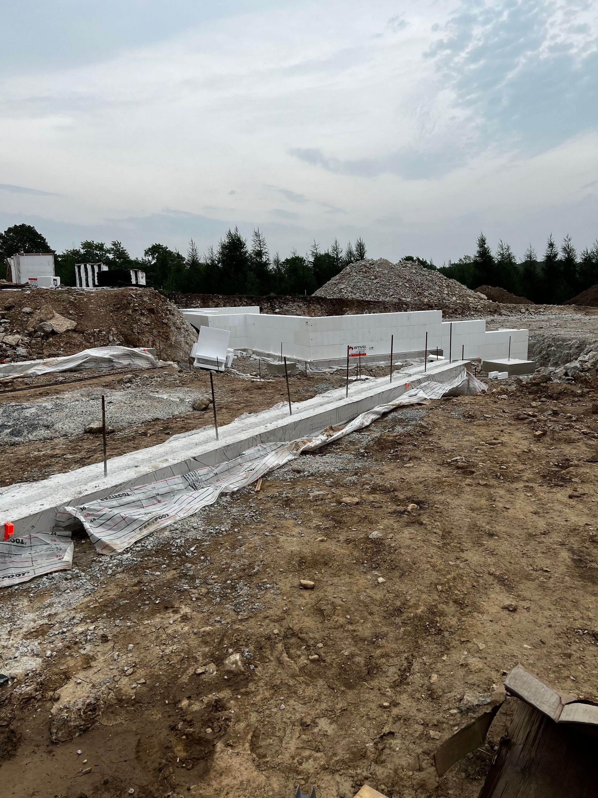 A construction site with a large body of water in the background.