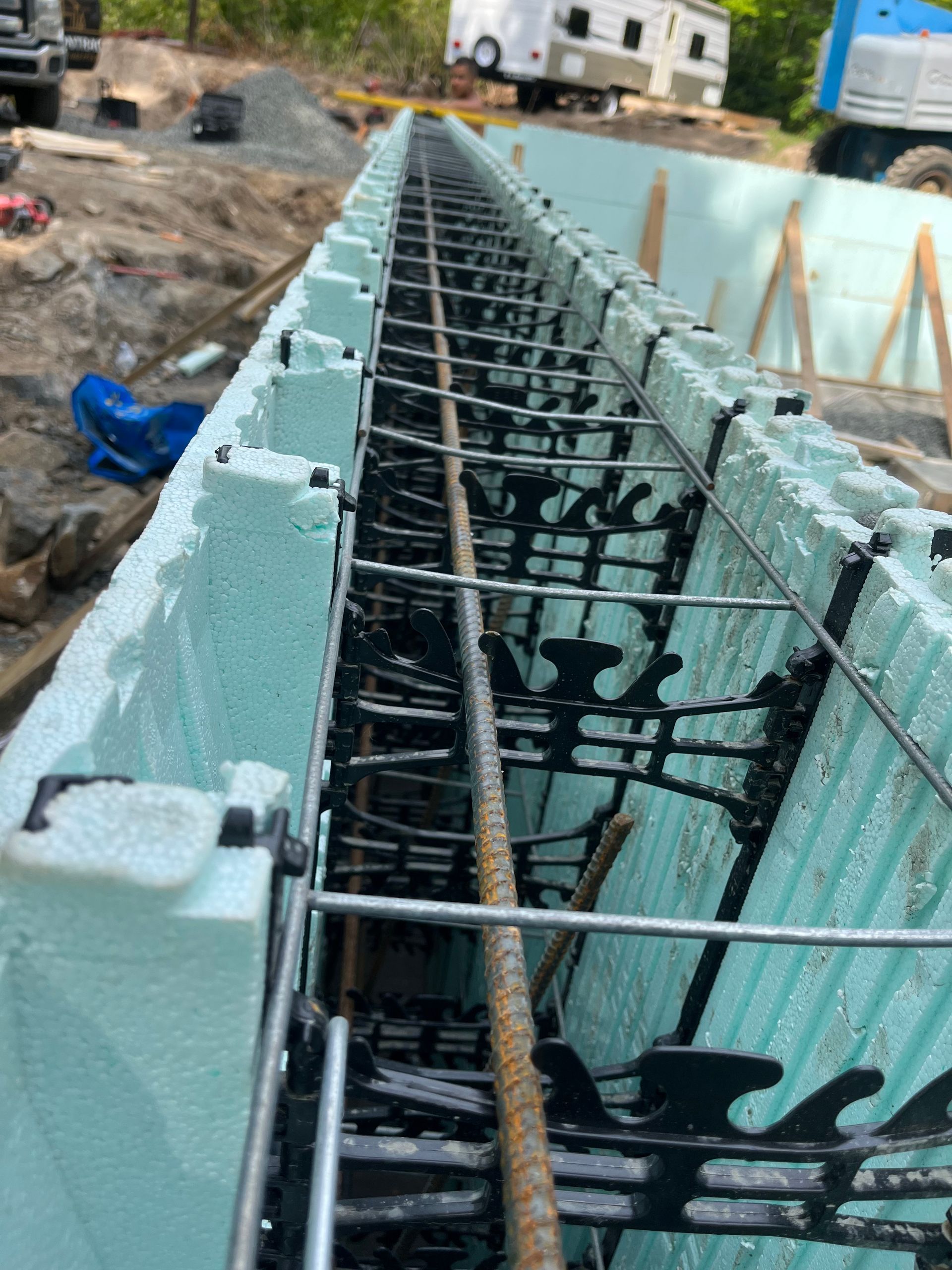 A concrete wall is being built on a construction site.