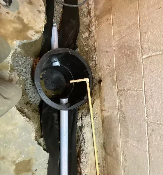 There is a hole in the wall with a pipe coming out of it.