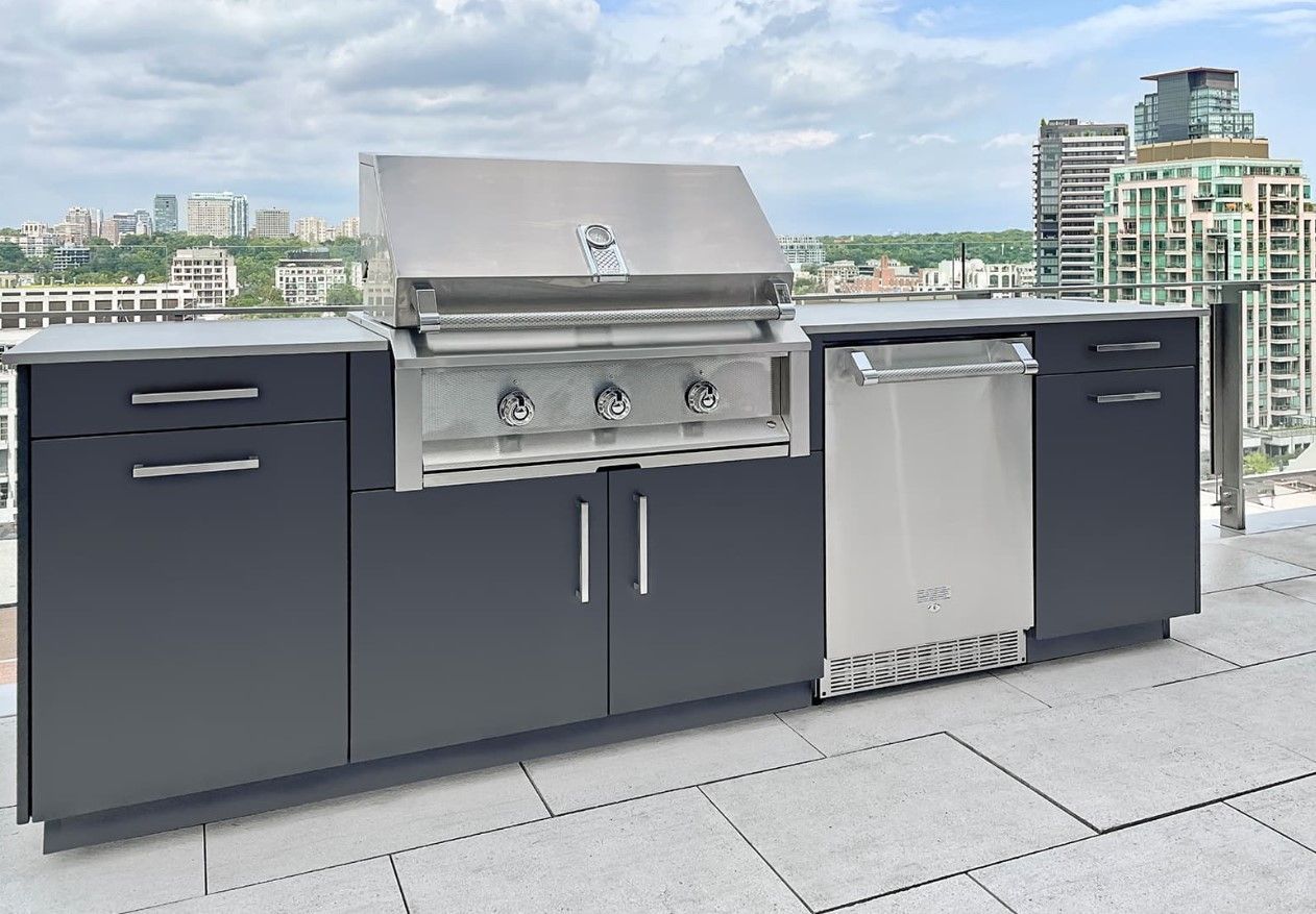 A large outdoor kitchen with a grill and a dishwasher