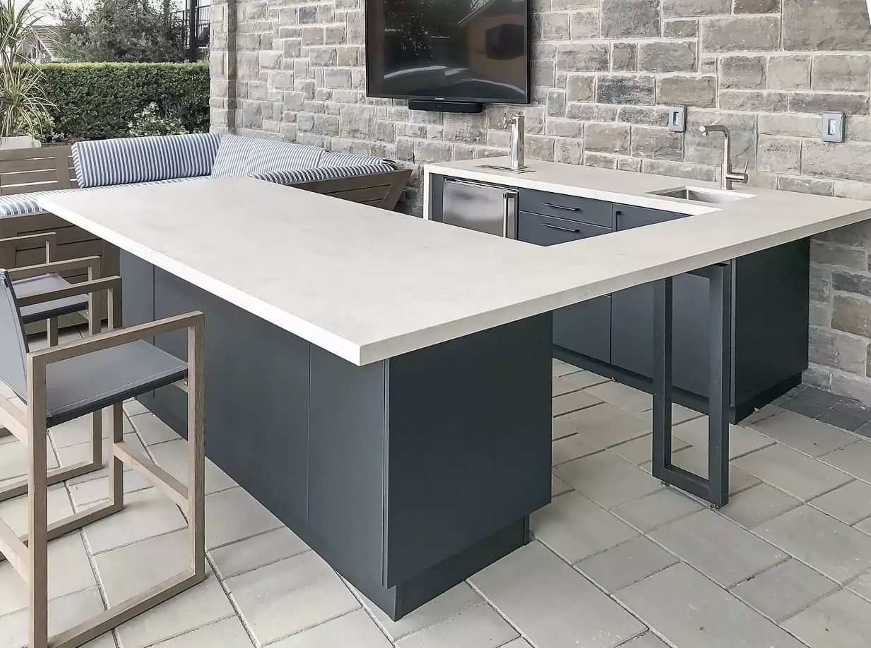 A patio with a table and chairs and a television on the wall.