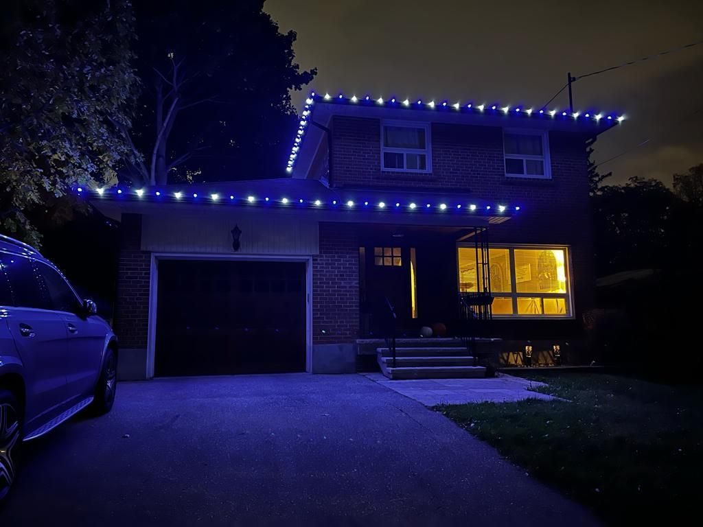 A house with blue lights on the roof and a car parked in front of it