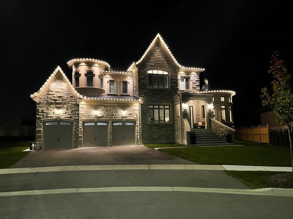 A large house is lit up at night with christmas lights