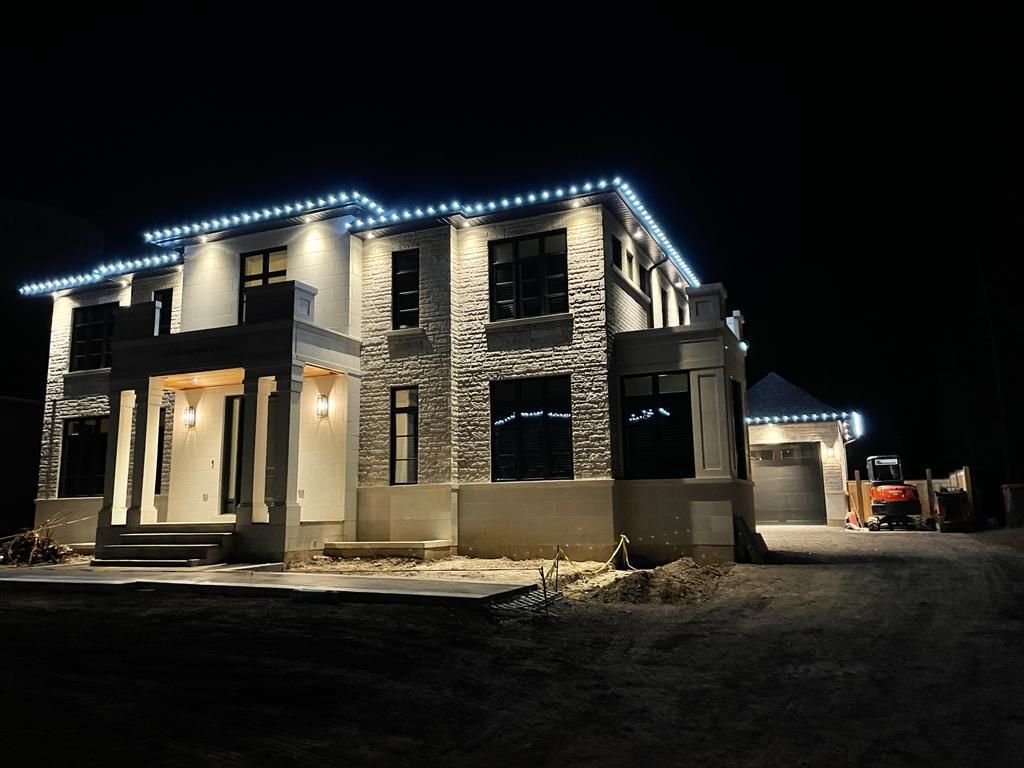 A large house is lit up at night with christmas lights