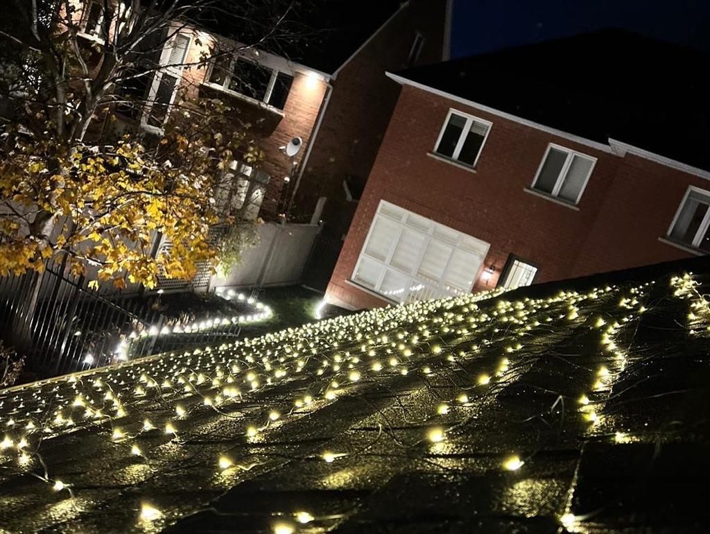 A house is lit up with christmas lights at night