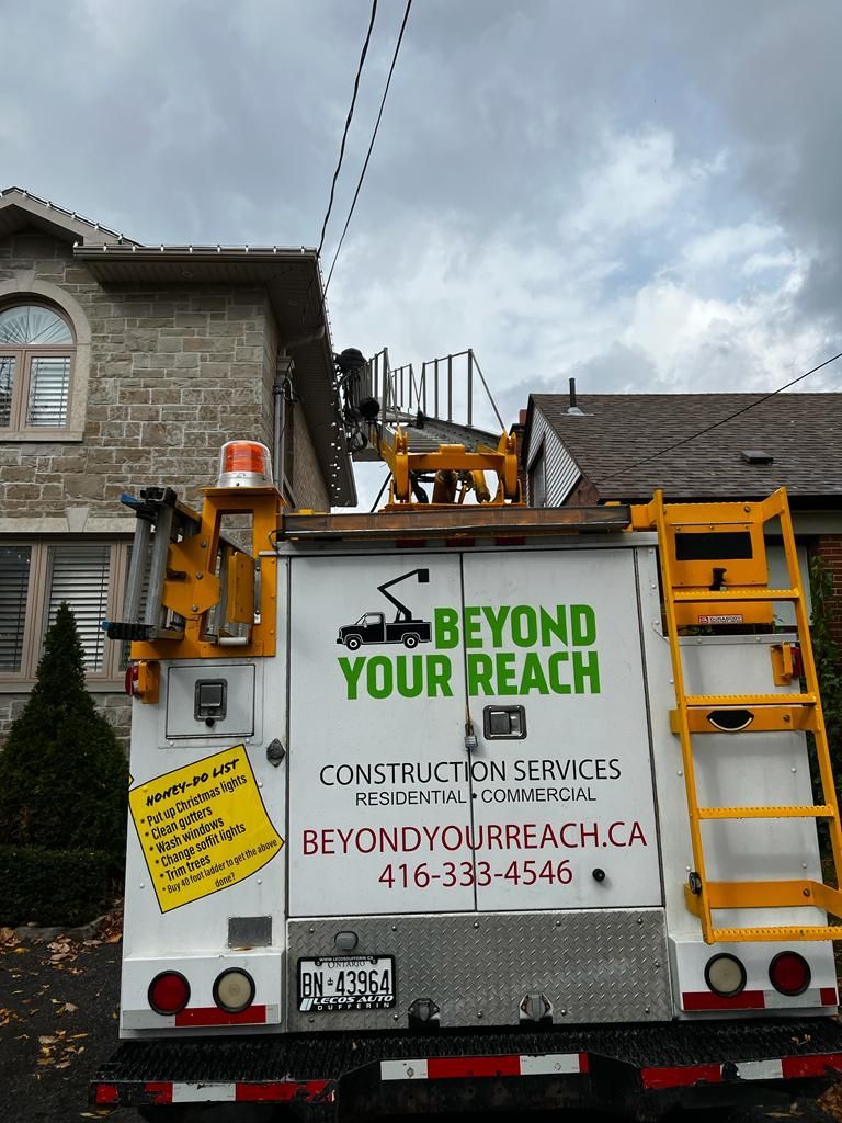 A beyond your reach truck is parked in front of a house