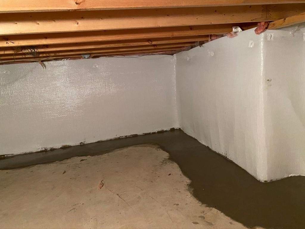 A basement with a concrete floor and white walls.