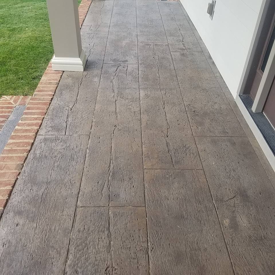 A brick walkway leading to a white building