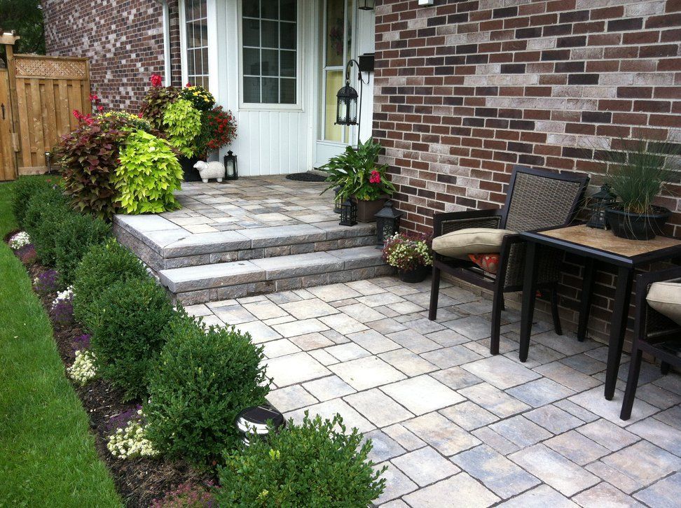 A brick house with a patio in front of it