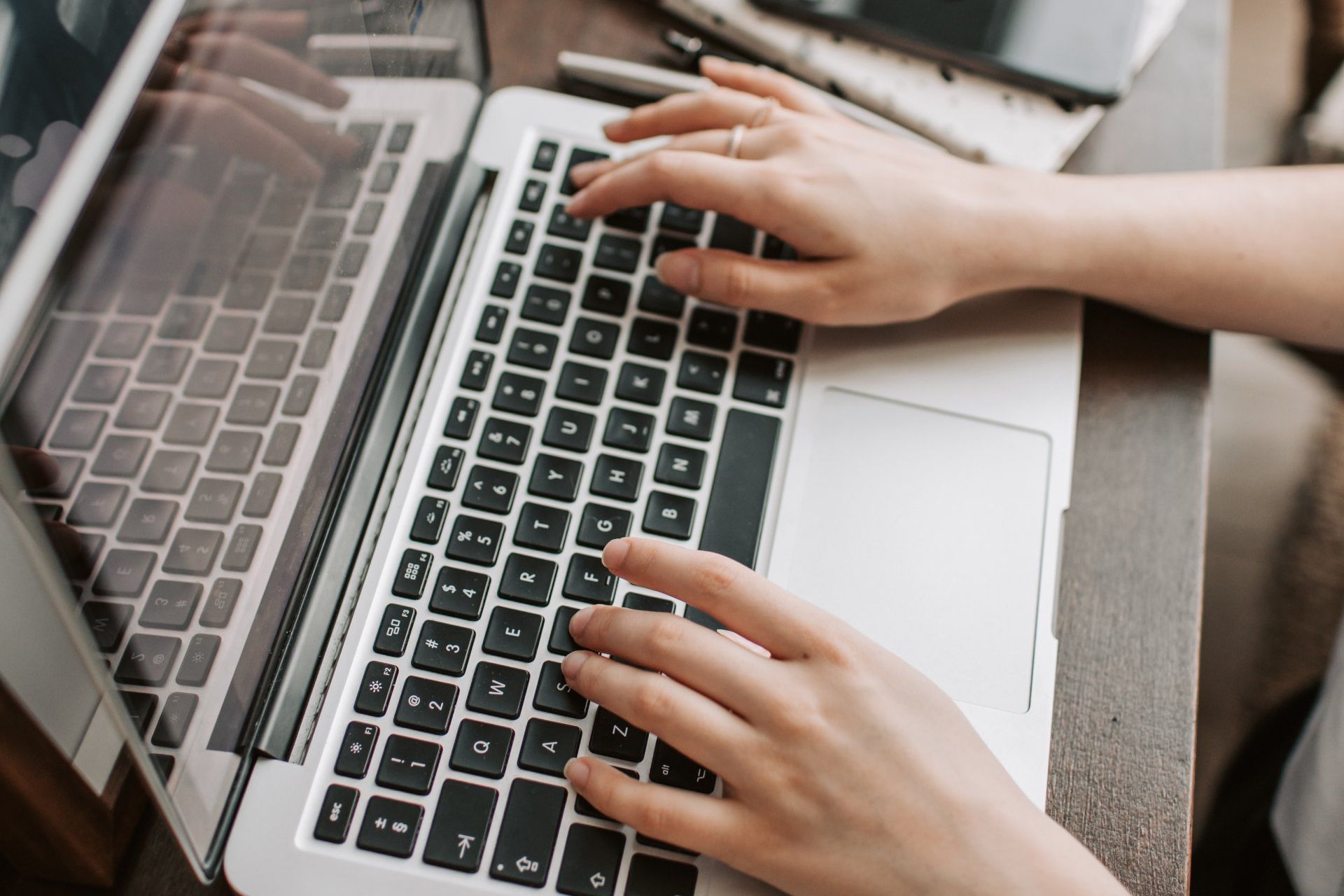 An image of person typing on a laptop at Overseas Filipino Workers