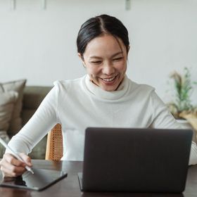 Image of a woman working with her laptop at Overseas Filipino Workers