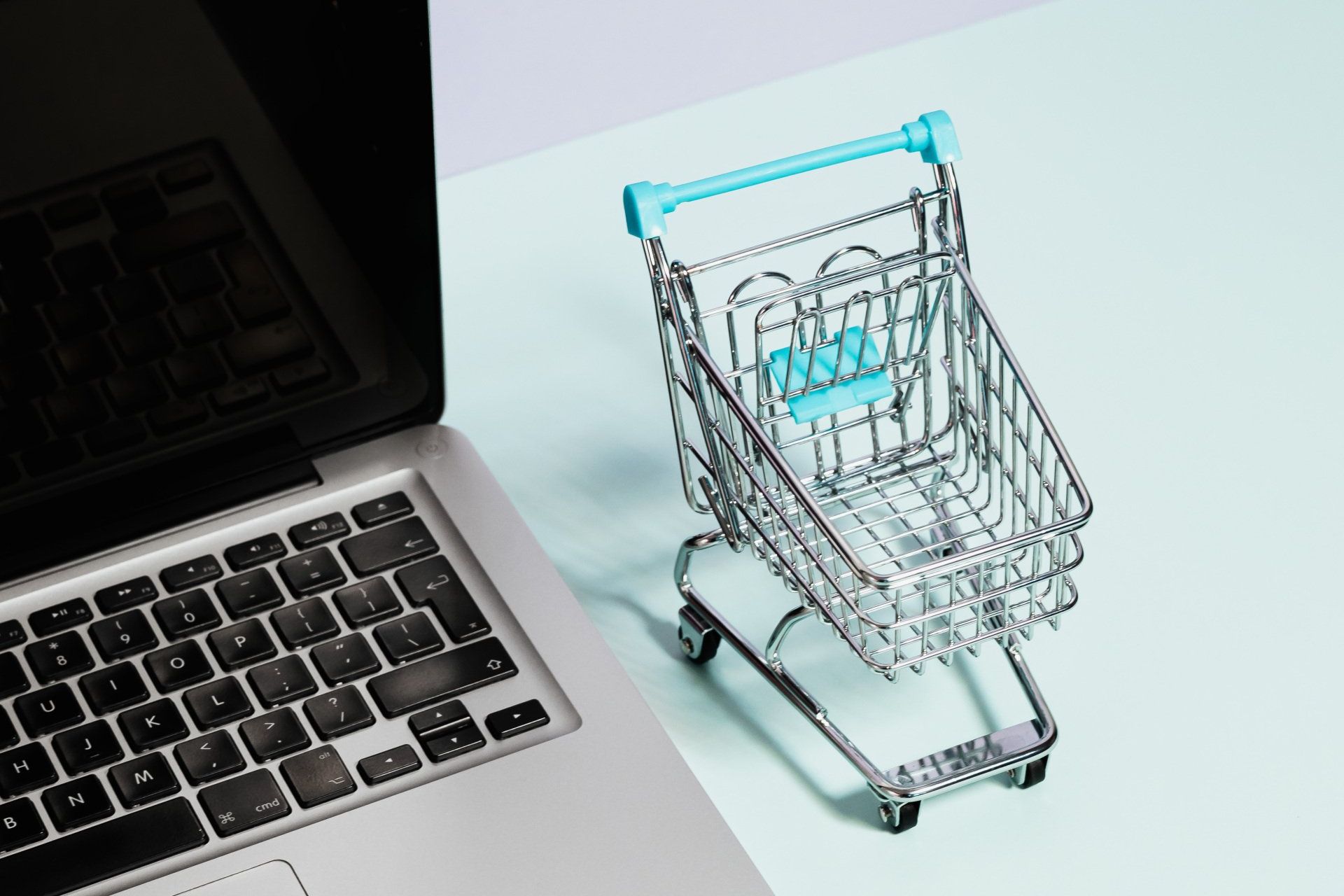 An image of a laptop with a small shopping cart at Overseas Filipino Workers