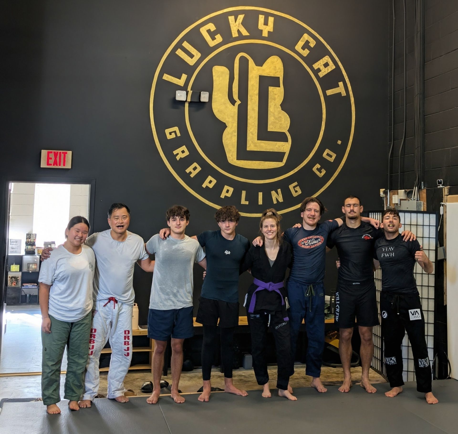 Adults practicing grappling drills at Lucky Cat Grappling Co. in Manalapan, NJ for fitness and confidence