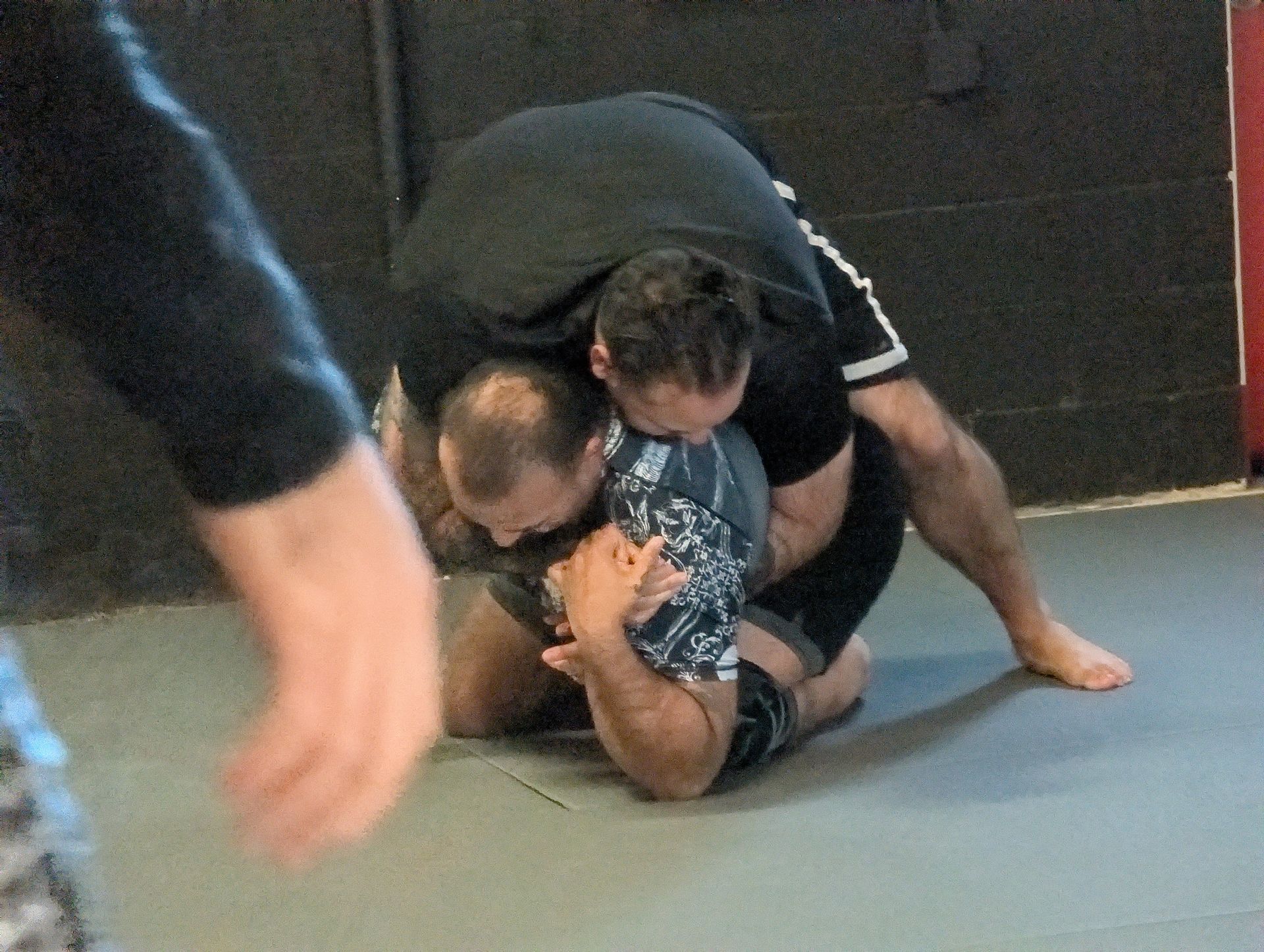 Adults practicing Jiu Jitsu drills at Lucky Cat Grappling Co. in Manalapan, NJ, building confidence and fitness