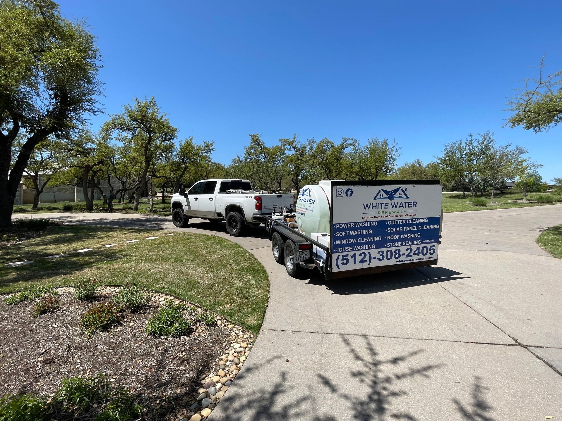 A truck is towing a trailer with a tank on it.