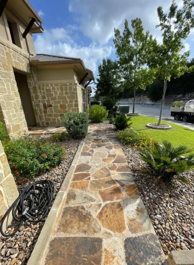A man is kneeling on a brick floor in a room.