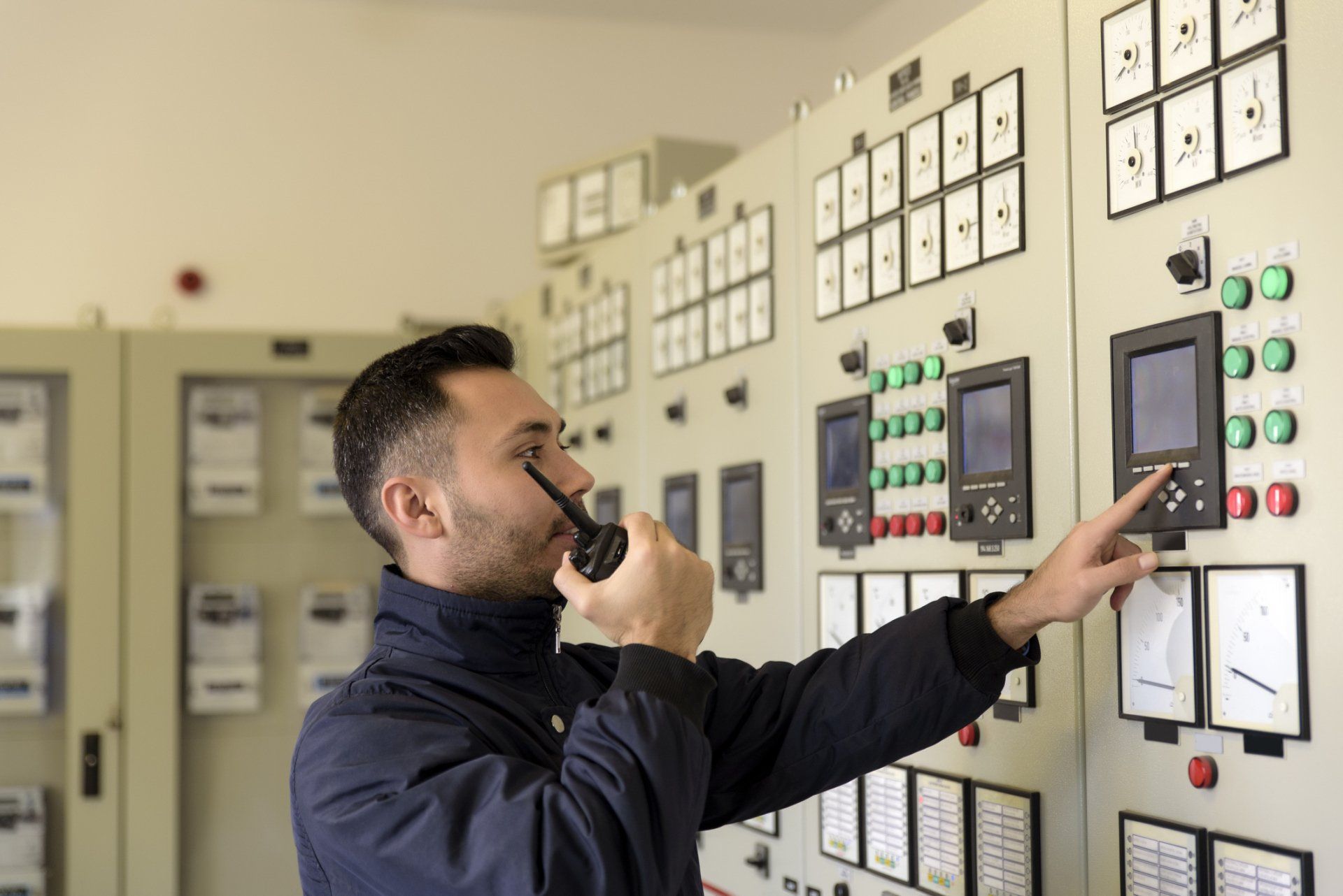 Man In Front Of Control Panel — Lodi, CA — Alamo Alarm Company Inc.