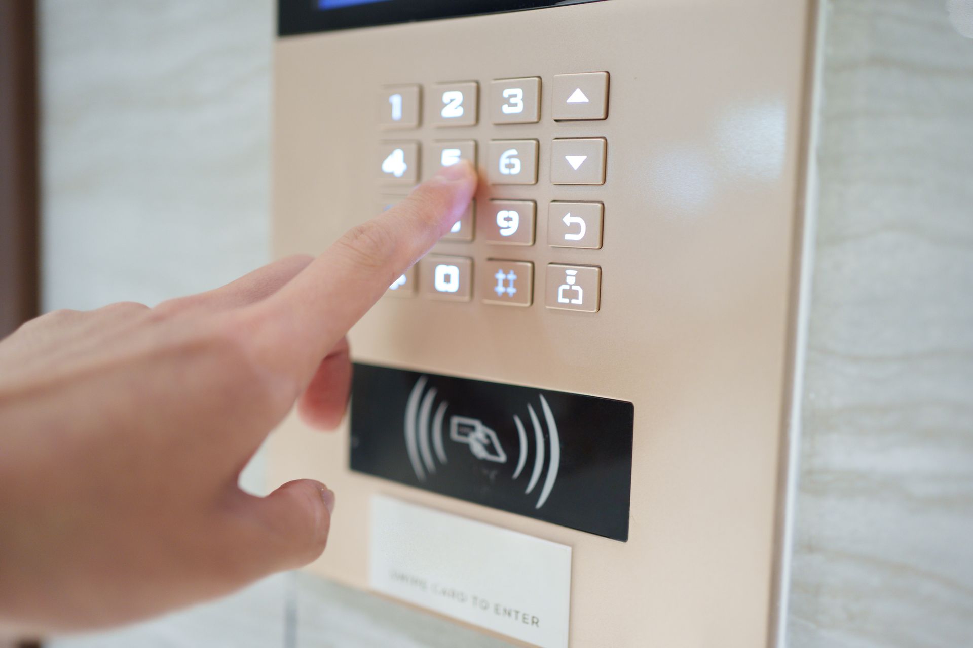 Person pressing a button on a keypad with card reader below.