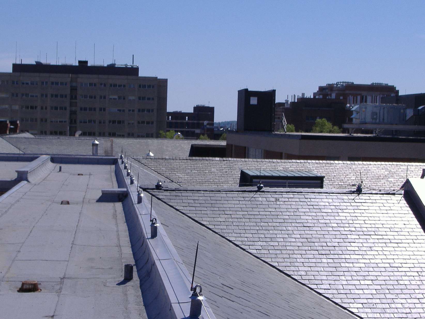 The roof of a building with a blue sky in the background