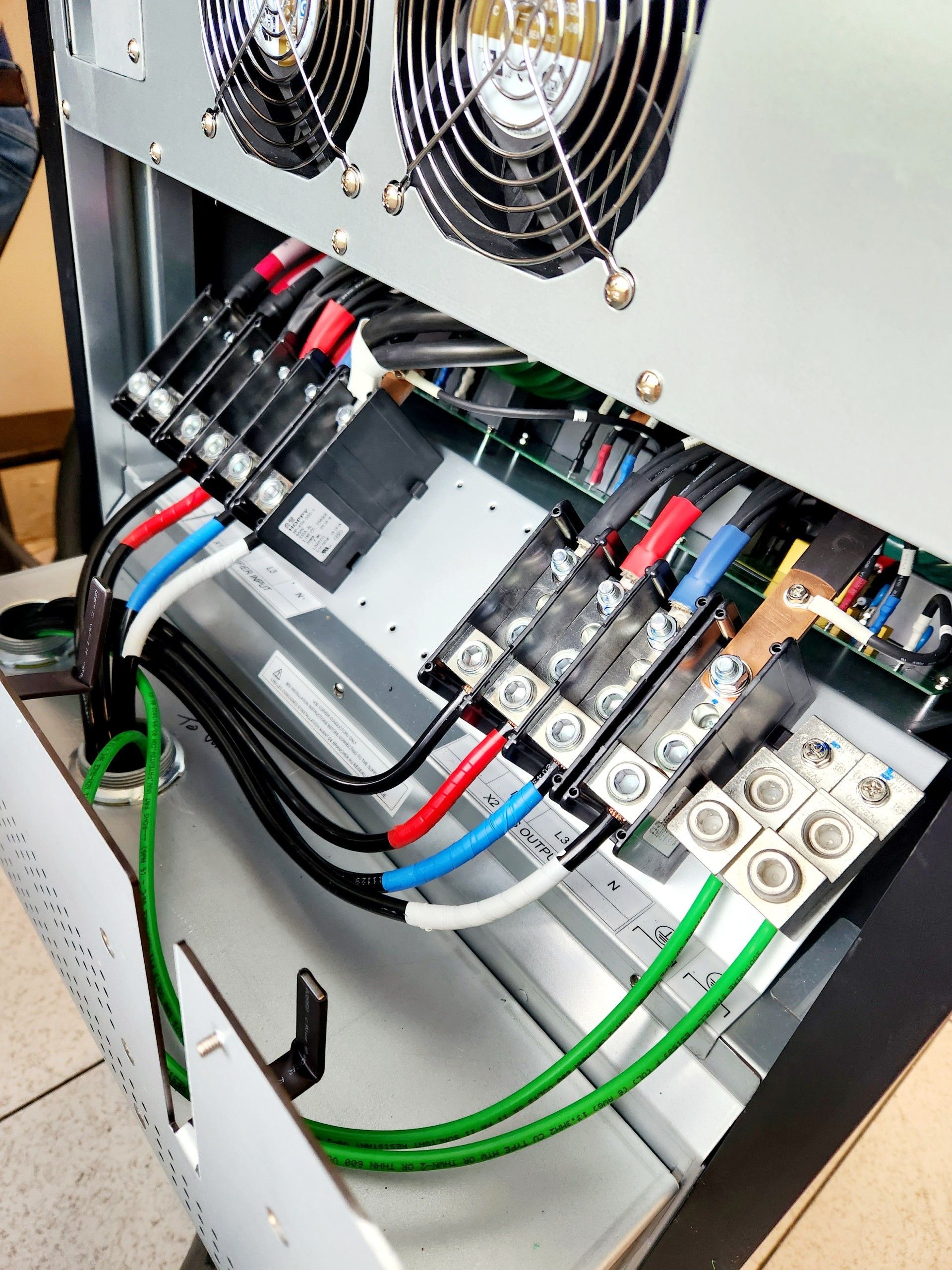 A computer with a lot of wires coming out of it