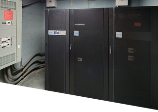 A room with a lot of electrical equipment and a clock that says 10:08