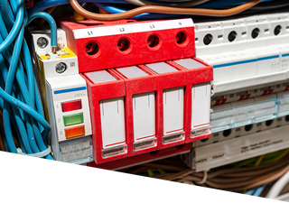 A red and white electrical device is sitting on top of a electrical box.