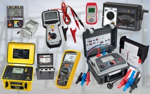 A bunch of electrical tools are sitting on a table.