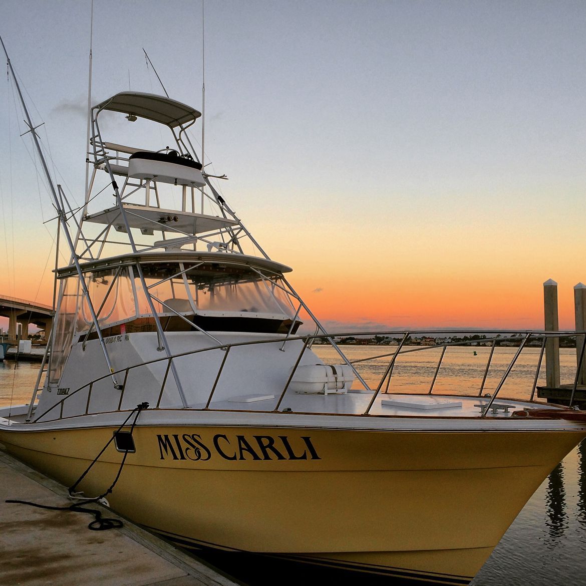 A boat named miss carla is docked at a dock