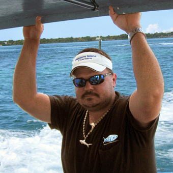 A man wearing a visor that says treasure island on it