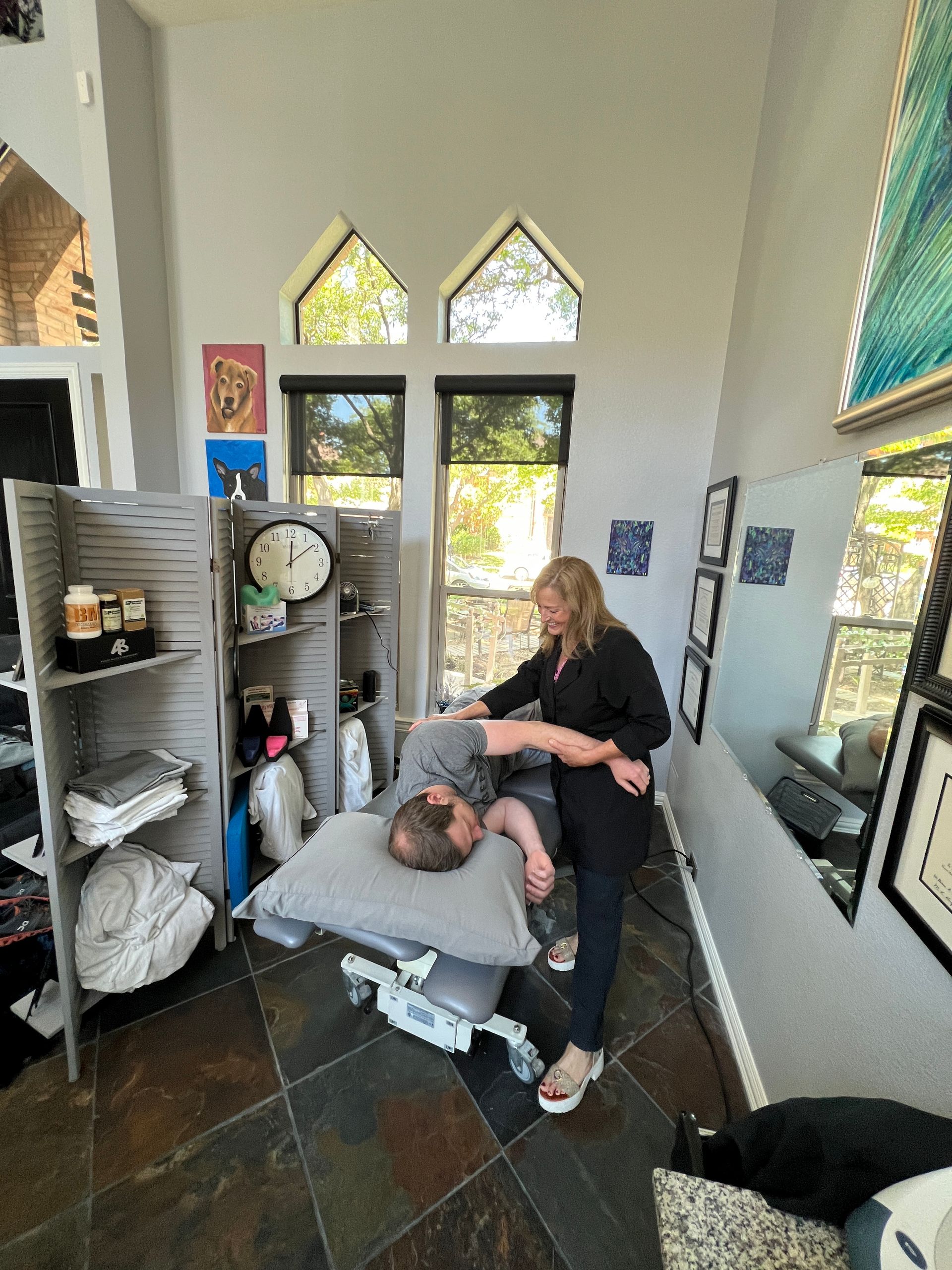 A woman is giving a man a massage in a room.