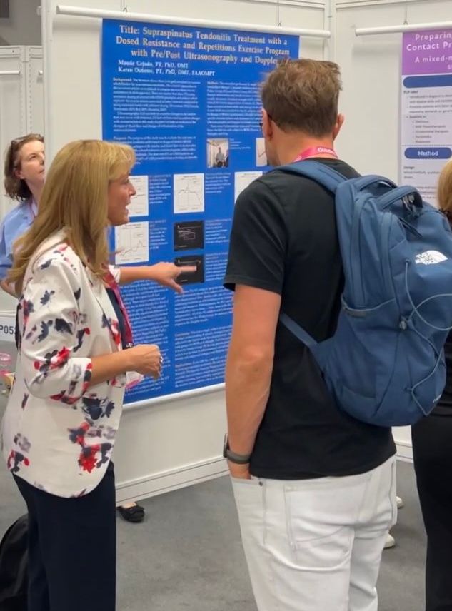 A man with a blue backpack stands in front of a poster