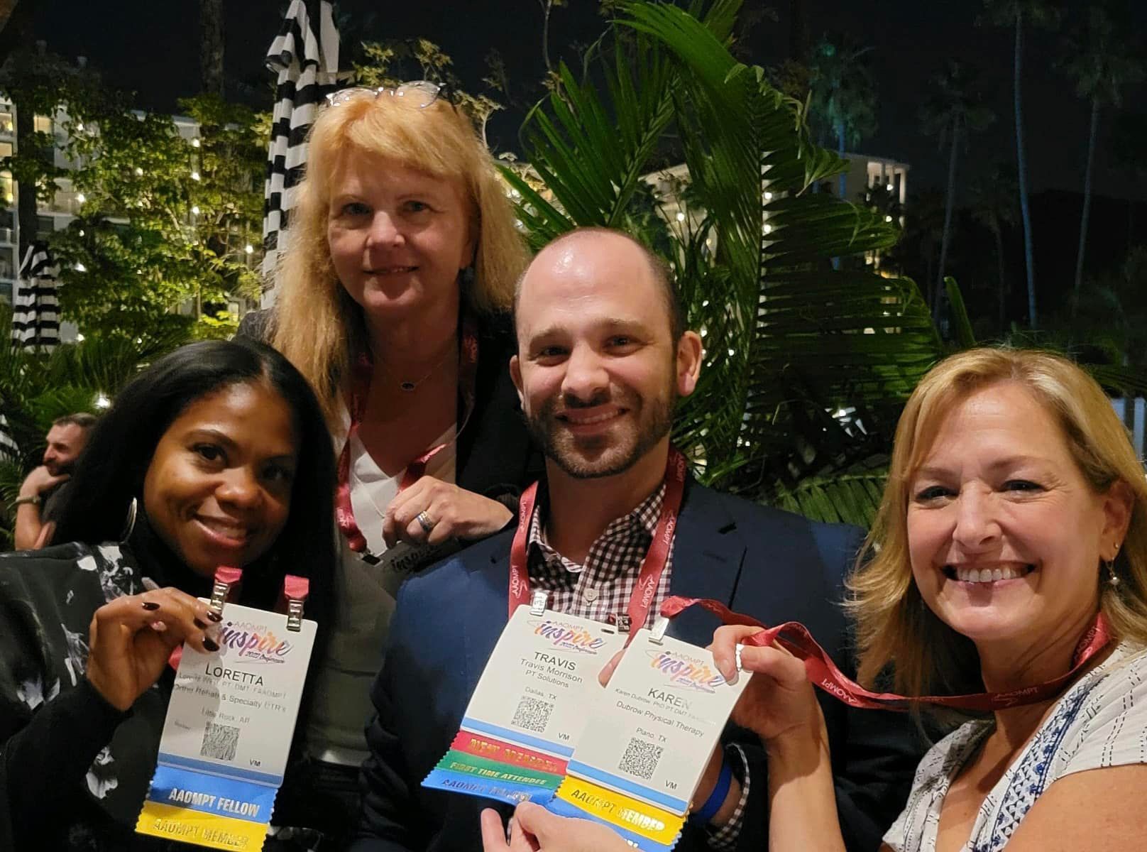 A group of people are posing for a picture while holding name tags.