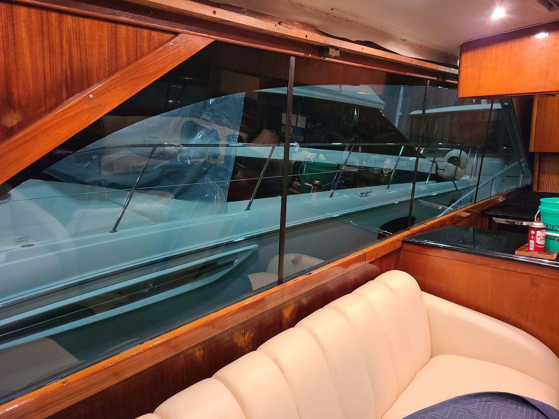 A boat is reflected in the window of a couch
